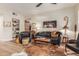 Living room with leather sofa, chairs, and a cowhide rug at 14950 W Mountain View Blvd # 4205, Surprise, AZ 85374