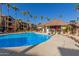 Community pool with lounge chairs and grilling station at 14950 W Mountain View Blvd # 4205, Surprise, AZ 85374