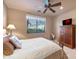 Bright bedroom featuring a queen-size bed and a wood dresser at 18947 E Lazo Ct, Rio Verde, AZ 85263