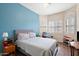 Bedroom with a tranquil blue accent wall and bay window at 2412 W Crimson Ter, Phoenix, AZ 85085
