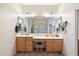 Double vanity bathroom with a large mirror and ample counter space at 2412 W Crimson Ter, Phoenix, AZ 85085