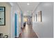 Long hallway with wood-look floors and a view to the backyard at 2412 W Crimson Ter, Phoenix, AZ 85085