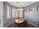 Bright dining room with wood table and four chairs, near a window at 2412 W Crimson Ter, Phoenix, AZ 85085