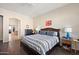 Comfortable bedroom with a striped bedspread and wood nightstand at 2412 W Crimson Ter, Phoenix, AZ 85085