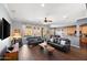 Spacious living room with dark leather sofas and hardwood floors at 2412 W Crimson Ter, Phoenix, AZ 85085