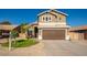 Two-story house with a brown garage door and a well-maintained lawn at 12626 W Indianola Ave, Avondale, AZ 85392