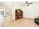 Living room with built-in entertainment center and ceiling fan at 12626 W Indianola Ave, Avondale, AZ 85392