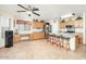 Kitchen with an island, wood cabinets, and tile floors at 12626 W Indianola Ave, Avondale, AZ 85392