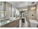 Modern bathroom with soaking tub, glass shower, and sleek fixtures at 8614 E Berridge Ln, Scottsdale, AZ 85250