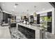 Open concept kitchen with expansive island, stainless steel appliances, and stylish pendant lights at 8614 E Berridge Ln, Scottsdale, AZ 85250