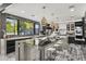 Stylish kitchen with dark cabinetry, quartz countertops, and modern pendant lighting at 8614 E Berridge Ln, Scottsdale, AZ 85250