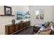 Cozy Gathering room with dark wood built-ins, a leather chaise lounge, and large TV at 21066 W Granada Rd, Buckeye, AZ 85396