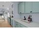Modern kitchen with teal cabinets, quartz countertops, and wine storage at 15912 W Central St, Surprise, AZ 85374