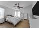 Spacious bedroom with wood-look floors, ceiling fan, and ample closet space at 15912 W Central St, Surprise, AZ 85374