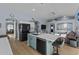 Open concept kitchen and living area with a large island and stainless steel appliances at 15912 W Central St, Surprise, AZ 85374