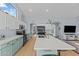 Open concept kitchen with island, stainless steel appliances, and light teal cabinets at 15912 W Central St, Surprise, AZ 85374