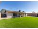 Backyard with artificial turf and covered patio at 4302 N 80Th Ln, Phoenix, AZ 85033