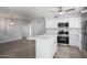 Modern kitchen with white shaker cabinets, quartz countertops, and stainless steel appliances at 4302 N 80Th Ln, Phoenix, AZ 85033