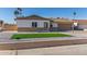 Single-story home with artificial turf landscaping and a 2-car garage at 4302 N 80Th Ln, Phoenix, AZ 85033