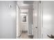 Bathroom hallway with light grey walls and wood-look tile flooring at 4302 N 80Th Ln, Phoenix, AZ 85033