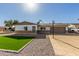 Single-story home with two-car garage and landscaped yard at 4302 N 80Th Ln, Phoenix, AZ 85033