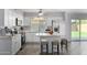 Modern white kitchen with island and stainless steel appliances at 4302 N 80Th Ln, Phoenix, AZ 85033