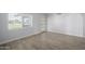 Clean and bright entryway with modern front door and wood-look tile flooring at 4302 N 80Th Ln, Phoenix, AZ 85033