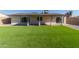 Large backyard with covered patio and grassy area at 4302 N 80Th Ln, Phoenix, AZ 85033