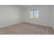 Bright bedroom with neutral carpeting and large window at 6560 N Loma Ct, Casa Grande, AZ 85194