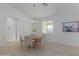 Bright dining room with wooden table and six beige chairs at 6560 N Loma Ct, Casa Grande, AZ 85194