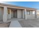 Home exterior with walkway leading to front door and covered porch at 6560 N Loma Ct, Casa Grande, AZ 85194