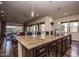 Granite kitchen island with dark wood cabinets at 27000 N Alma School Pkwy # 2004, Scottsdale, AZ 85262