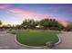 Artificial turf putting green surrounded by desert landscaping at 15406 E Cavedale Dr, Scottsdale, AZ 85262