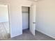 Bedroom with closet and view into another room at 8572 W Raven Dr, Arizona City, AZ 85123