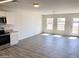 Bright and airy living room with wood-look floors and access to the backyard at 8572 W Raven Dr, Arizona City, AZ 85123