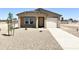 Newly built home with a single-car garage and desert landscaping at 8572 W Raven Dr, Arizona City, AZ 85123