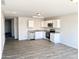 Open concept kitchen with white cabinets and stainless steel appliances at 8572 W Raven Dr, Arizona City, AZ 85123