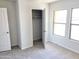 Cozy bedroom with neutral carpeting and a spacious closet at 201 S Apache Ave, Eloy, AZ 85131