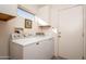 Laundry room with side-by-side washer and dryer, and overhead cabinets at 18483 N Deer Grass Ct, Surprise, AZ 85374