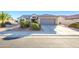 Single story home with attached two car garage and desert landscaping at 18483 N Deer Grass Ct, Surprise, AZ 85374
