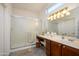 Bathroom with a large vanity, walk-in shower, and updated fixtures at 18483 N Deer Grass Ct, Surprise, AZ 85374