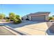 Single story home with attached two car garage and desert landscaping at 18483 N Deer Grass Ct, Surprise, AZ 85374