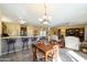 Kitchen with breakfast bar and views to living and dining areas at 18483 N Deer Grass Ct, Surprise, AZ 85374