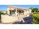 Covered patio with seating area and desert landscaping at 18483 N Deer Grass Ct, Surprise, AZ 85374