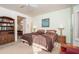 Spacious bedroom with two twin beds, built-in shelving, and ensuite bathroom access at 18483 N Deer Grass Ct, Surprise, AZ 85374