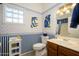 Clean bathroom with blue and white striped wallpaper at 18483 N Deer Grass Ct, Surprise, AZ 85374