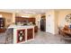 Kitchen boasts a breakfast bar, built-in wine rack, and modern appliances at 18483 N Deer Grass Ct, Surprise, AZ 85374