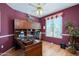 Well-lit home office with built-in cabinetry and wood floors at 18483 N Deer Grass Ct, Surprise, AZ 85374