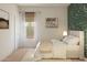 Well-lit bedroom with large window and patterned wallpaper at 23388 W Burton Ave, Buckeye, AZ 85326