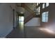 Two-story entryway with a curved staircase and tile flooring, leading to an open living area at 13510 W Merrell St, Avondale, AZ 85392